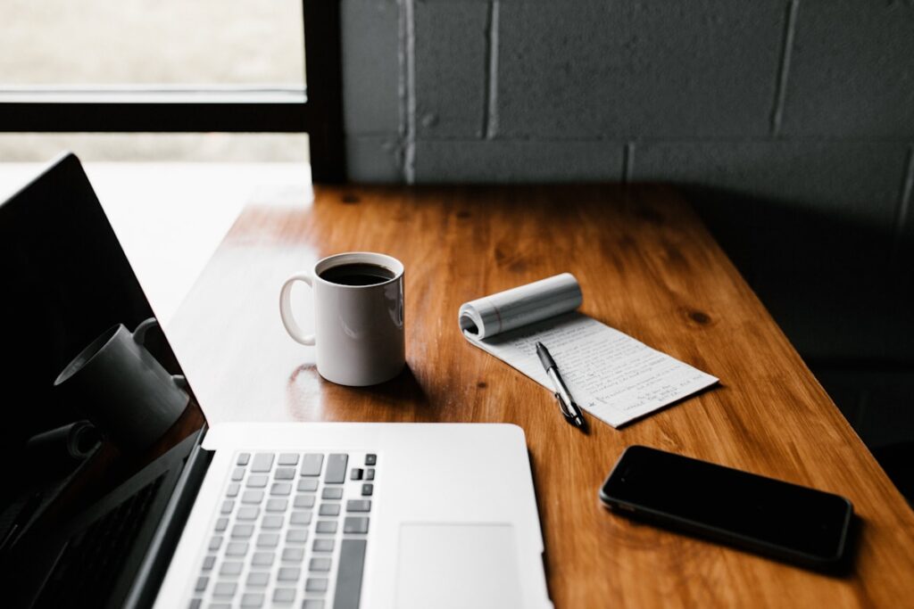 Professional workspace with laptop notebook and coffee for planning online course marketing strategy and sales funnel - Email Marketing Blueprint for Online Course Creators
