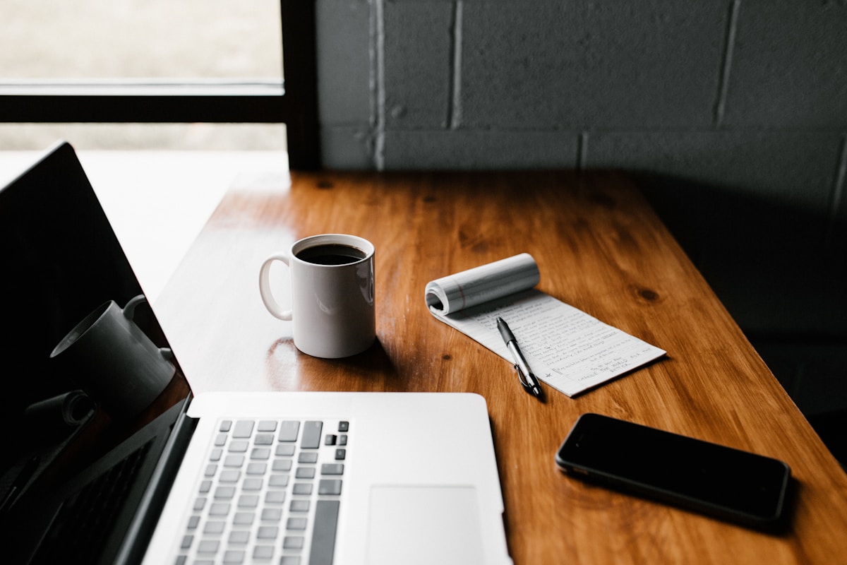 Professional workspace with laptop notebook and coffee for planning online course marketing strategy and sales funnel