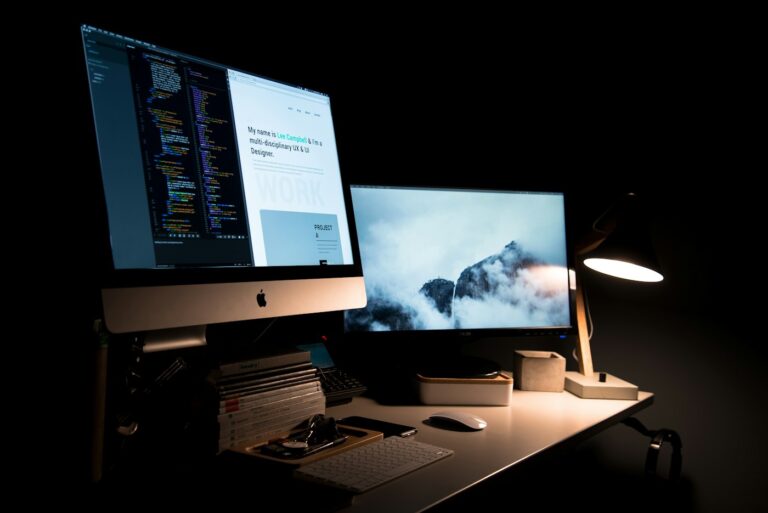 Course creator building an online course landing page layout with a wireframe visible on a laptop screen